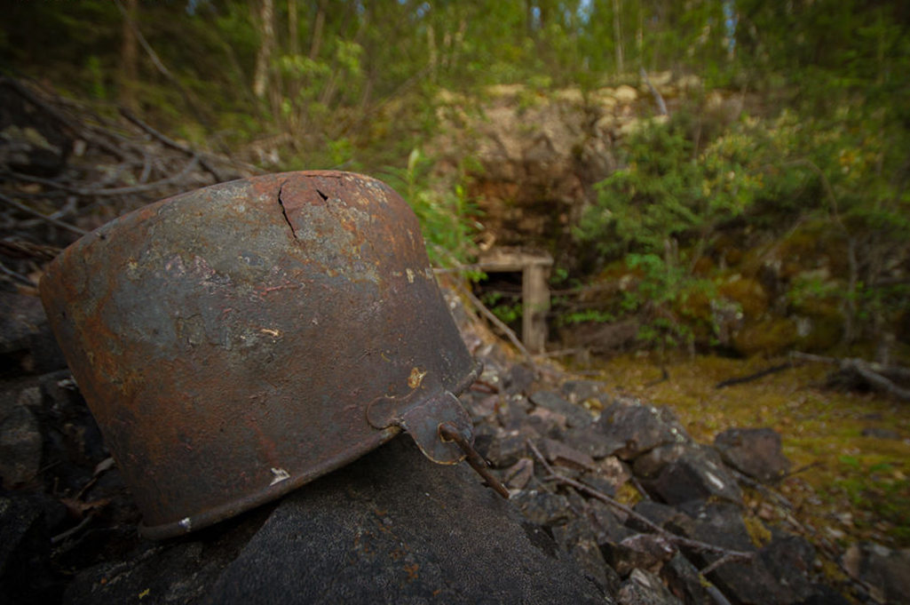 An old bucket sits at the entrance of an abandoned mine located along the shores of Tazin Lake in Northern Saskatchewan